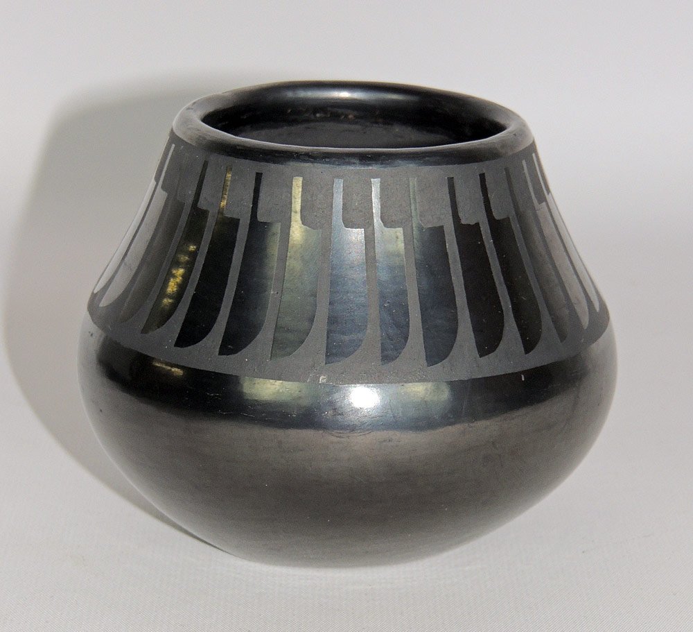 Maria Martinez / Popovi San Ildefonso Blackware Vase: Maria Martinez / Popovi San Ildefonso blackware vase with a bulbous shape and repeating feather design. Signed "Maria Popovi" on base. 3-3/4" tall x 4-1/4" wide.