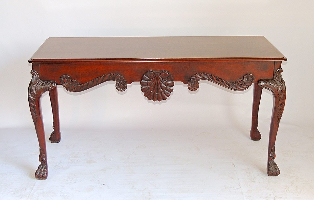 Baker Georgian-style Console Table: Georgian-style mahogany console table with rectangular top, shell carved skirt, and paw feet. Baker Furniture. 30" tall, 57" wide, 22" deep. From a Villanova, PA Estate.