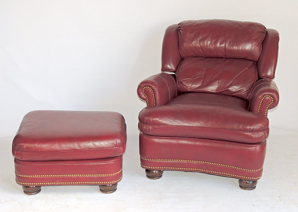 Hancock and Moore Leather Lounge Chair and Ottoman: Hancock and Moore burgundy leather reclining lounge chair with brass nail head trim, and matching ottoman. Chair: 33" tall, 34" wide, 39" deep. From a Villanova, PA Estate.