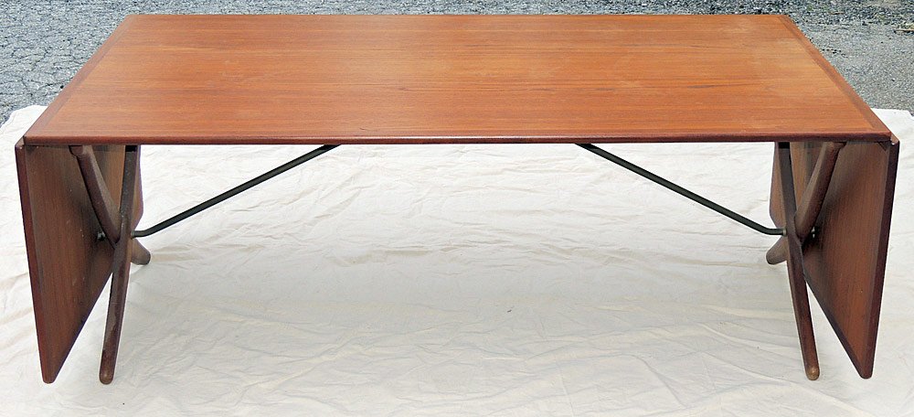 Hans Wegner for Andreas Tuck Dining Table: Hans Wegner for Andreas Tuck dining table. Denmark. Teak top with two drop sides over curved legs. Marked "Fabrikat: Andr Tuck Arkitect: Hans J. Wegnerâ€. 29" tall, 52" wide, 34" deep. Extended to