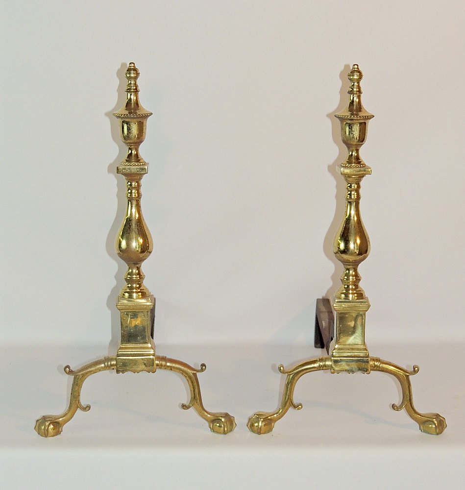 Pair of Virginia Metalcrafters Andirons: Colonial Williamsburg reproduction, pattern number CW100-1. 24" tall x 13" wide x 22" deep. Provenance: From a prominent estate in historic New Castle, DE.