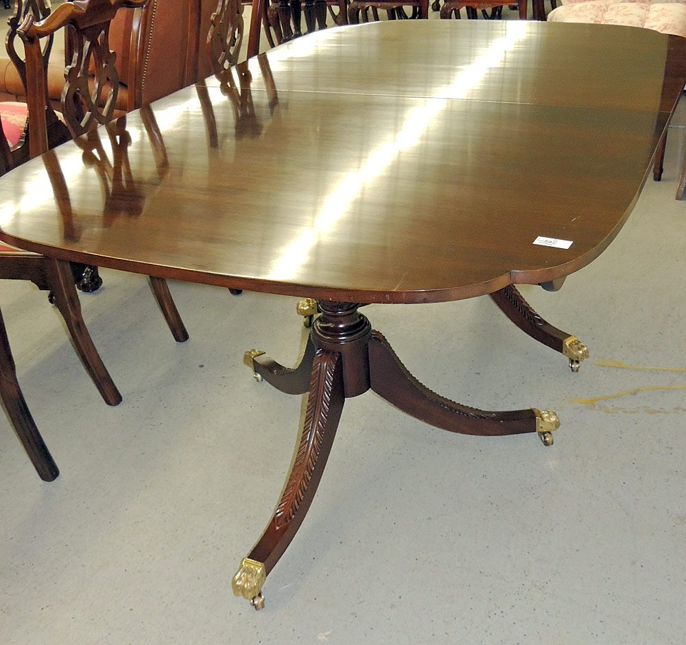 Stickley Dining Room Table: Mahogany, with clipped corners and carved pedestal base. Four self-storing leaves. 30" tall x 17" long x 46" wide. Leaves: 12" wide.