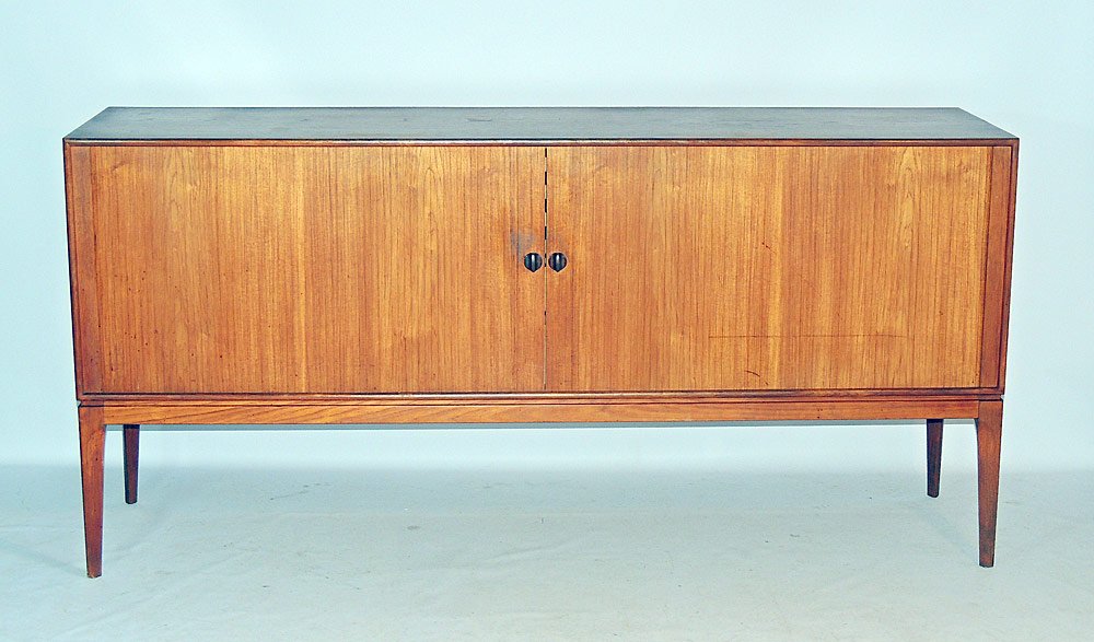 John Stuart Teak Credenza: With tambour doors. Interior with six shelves flanked by open shelves. "John Stuart" tag in drawer. 34-1/4" tall x 71" wide x 19" deep.