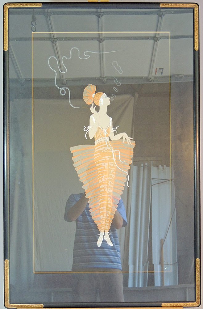 Erte Serigraph: Depicting an Art Deco woman smoking a cigarillo. Signed lower right "Erte" and numbered LXIII/CL (63/150). Framed under plexiglass. Image:37" tall x 21-1/4" wide.
