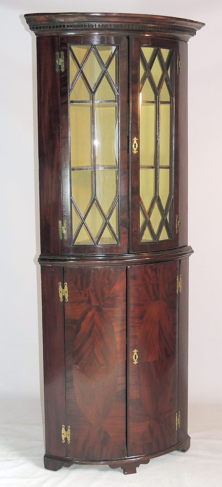 Georgian Corner Cupboard: Mahogany, with bow front and Greek-key carved cornice. 70-1/2" tall x 29" wide x 20-1/2" deep.