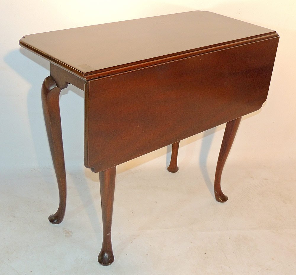 Kittinger Mahogany Drop Leaf Table: Williamsburg Adaptation. With a single drop leaf. 26" tall x 31" wide x 10" wide.