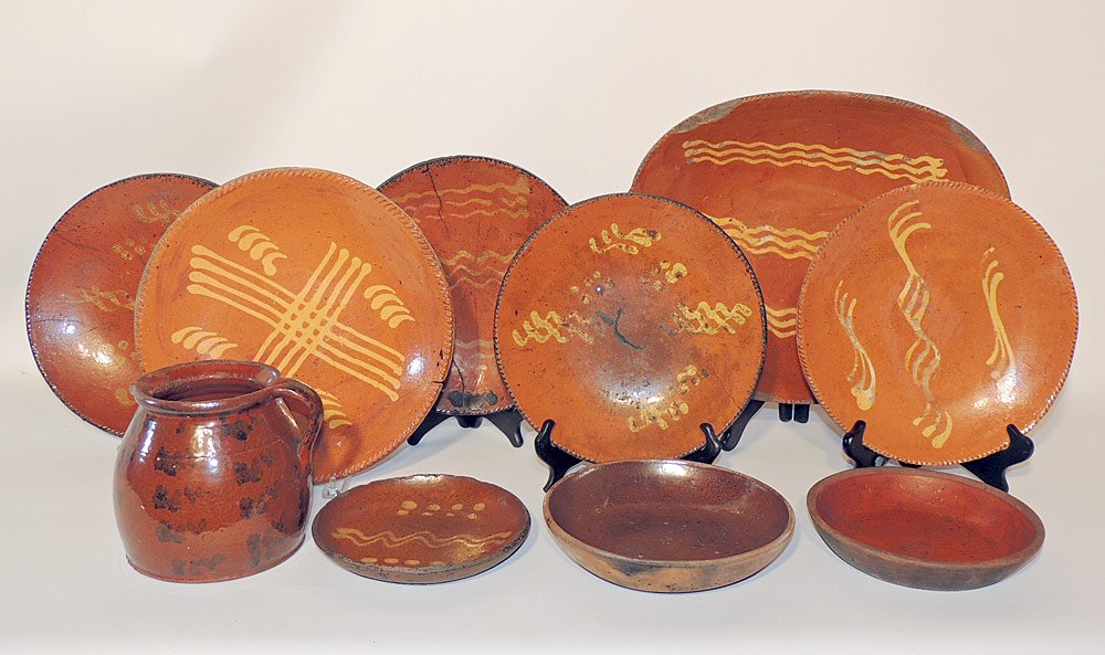 10 Pieces of Pennsylvania Redware: 19th century. Most with slip decoration. Loaf dish: 15-1/2" wide.