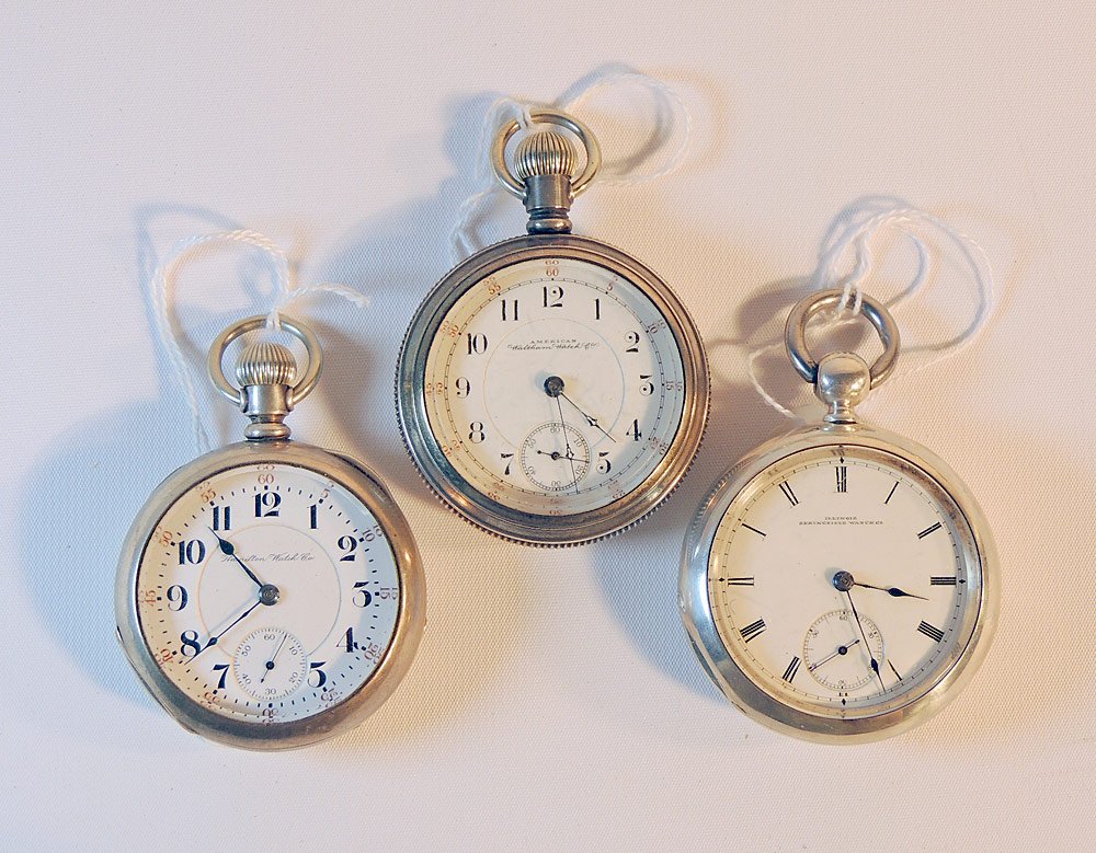 Three Silver Open-Face Pocket Watches: To include: Coin silver Hamilton 944. Coin silver key-wind Illinois Dean. Sterling Waltham Appelton Tracy. Largest: 2-3/8 in. diameter.