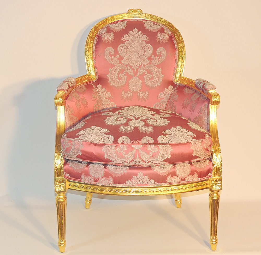 Louis XVI Style Bergere: Louis XVI style bergere. 20th century. With a carved gilt frame and pink damask upholstery. On fluted legs. 36" tall x 25" wide x 28" deep. Provenance: From a prominent Centreville, DE Estate.