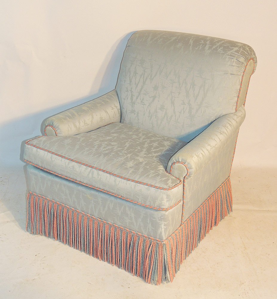 Upholstered Slipper Chair: Upholstered slipper chair. With rolled back, pink and blue trim, and tassels. 36" tall x 30" wide x 36" deep. Provenance: From a prominent Centreville, DE Estate.
