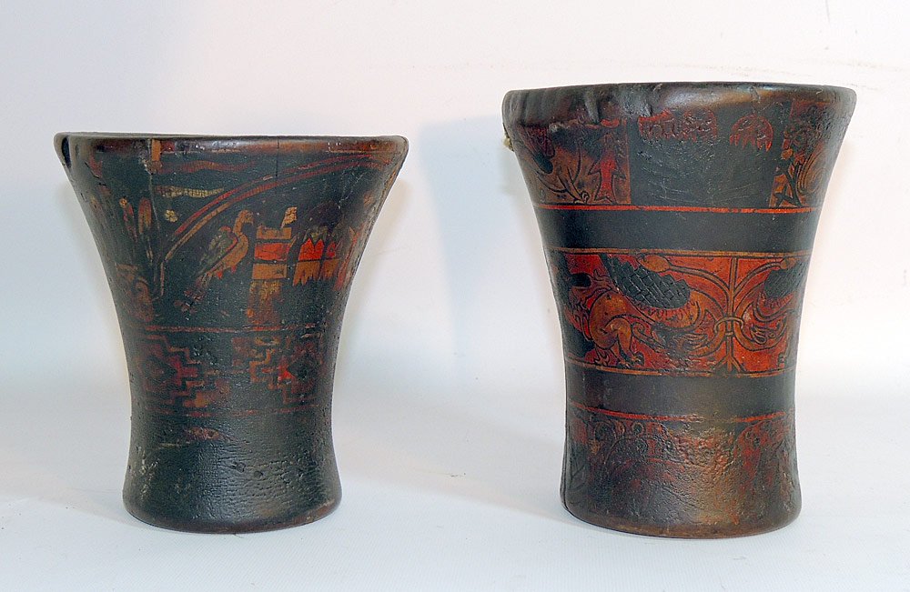 Two Pre-Columbian Polychromed Carved Wood Keros: Two Pre-Columbian carved wood keros. Inca. The larger depicting a dragon-type creature with foliate design. The smaller with figures and birds. Larger: 7-1/2" tall x 6" top diameter.