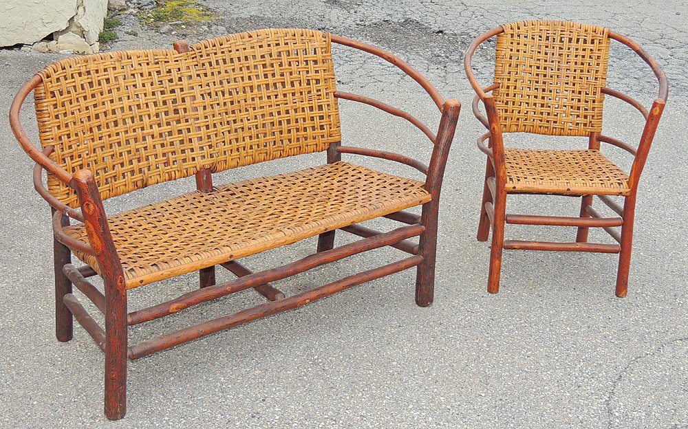 Old Hickory Settee and Chair: Old Hickory adirondack twig-form settee and chair with woven seats. Settee appears to be unmarked. Settee: 34 x 56 x 21 in. Chair: 33 x 28 x 20 in.