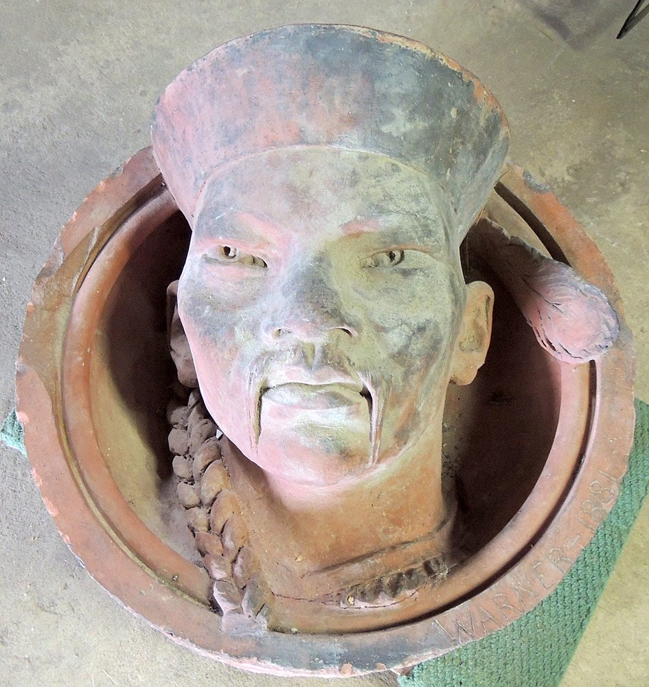 Architectural Terracotta Medallion: Architectural terracotta building medallion of a Japanese face. Signed "Warner", and dated 1881. 24 in. diameter, 12 in. deep.