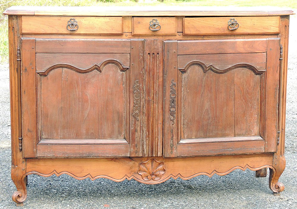 Country French Buffet: Country French buffet with three drawers over two cupboard doors. Case has a shaped skirt and shell-carved center. 37 x 55 x 16 in.