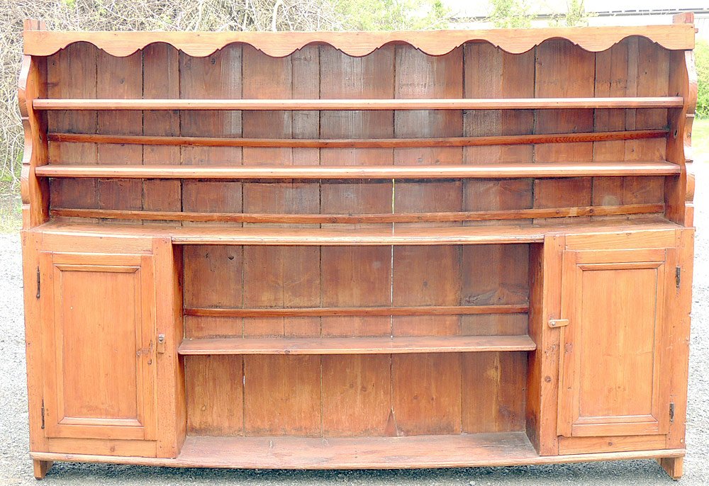 Antique Welsh Yewwood Cupboard: Antique Welsh yewwood cupboard with an open top, shaped overhang, and two cupboard doors in base. 67 x 97 x 13 in.