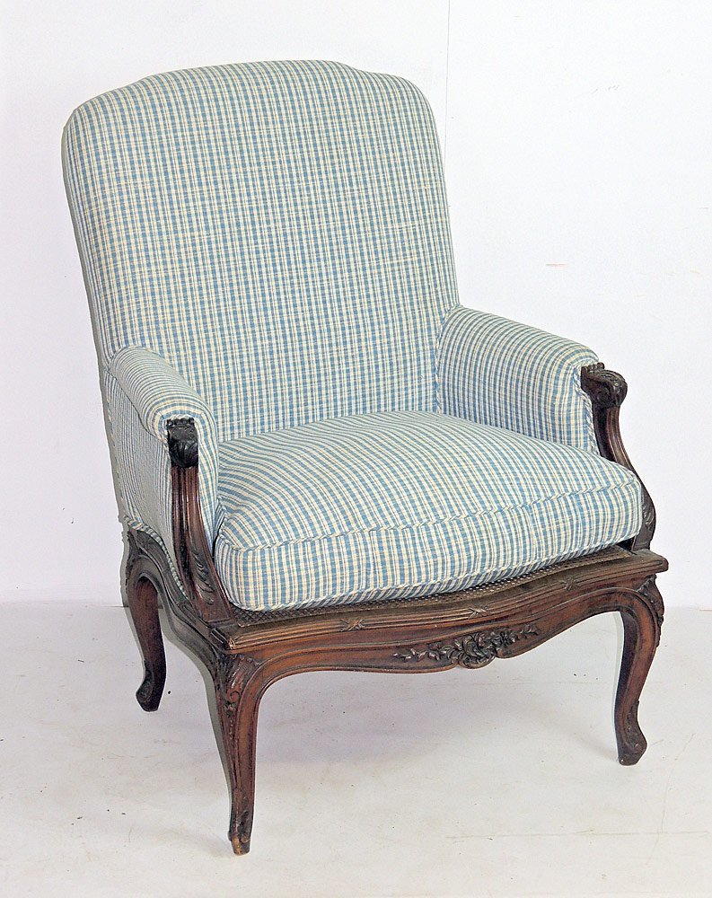 Antique French BergÃ¨re: Antique French bergÃ¨re with a carved frame with upholstered back and cushion over a caned seat. 38 x 29 x 22 in.