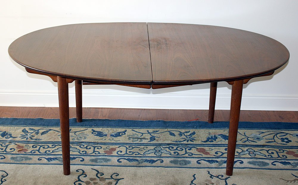 Hans Wegner Teak Extension Dining Table: Hans Wegner teak extension dining table. Denmark, 20th Century. With three 21 in. leaves and one 12 in. leaf. Height: 29 in. Length: 69 in. Width: 52 in.