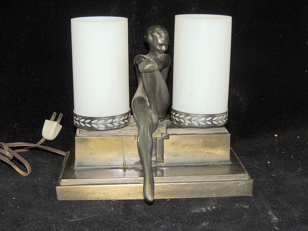 Frankart Figural Lamp with Two Cylinder Shades: Frankart figural lamp of enameled metal with a nude seated between two white cylinder shades. Marked. H: 8in. W: 9in. D: 5in.