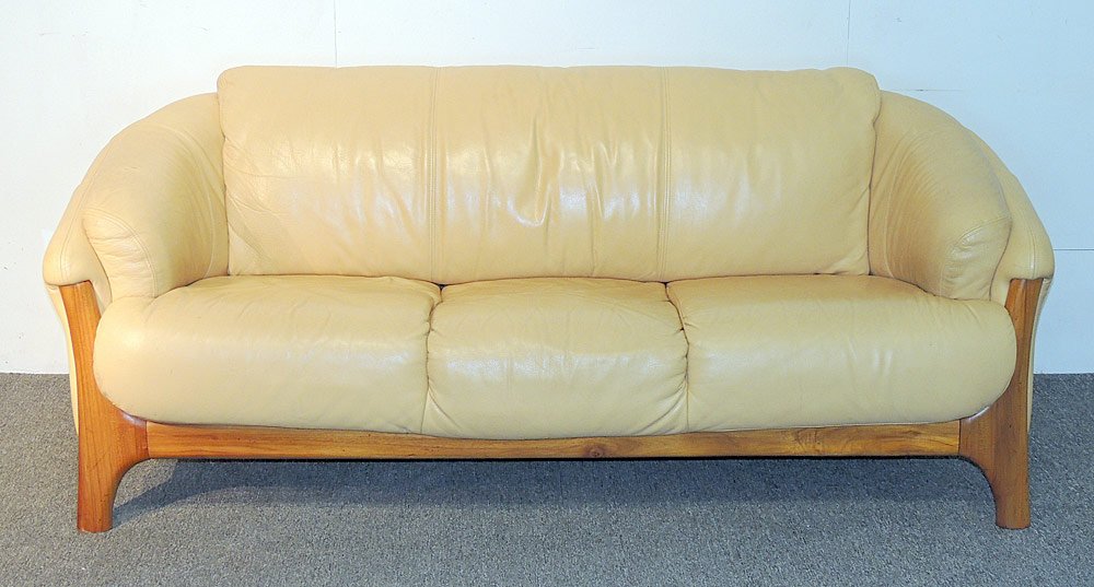 Danish Modern Teak and Leather Sofa: Danish modern sofa with leather upholstery and teak legs. H: 28 in. W: 75 in. D: 35 in.
