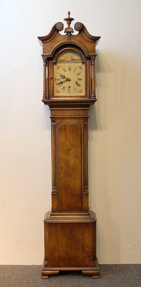 20th C. Bench-Made Dwarf Clock: 20th C. Bench-made dwarf clock with a broken-arch pediment top, hand-painted dial with rocking ship movement, quarter columns flanking a shaped waist door, and bracket feet. Unsigned. H 57-1/2. W 13.
