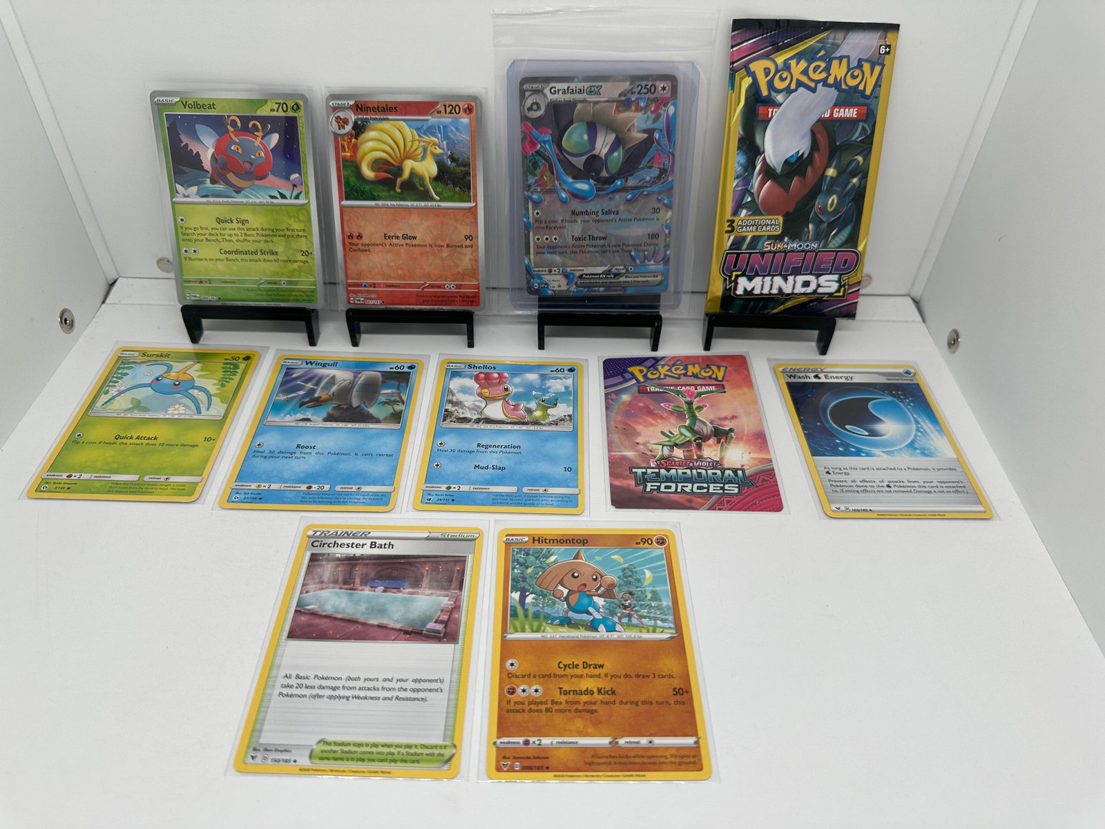 (11) TCG Pokemon Unified Minds pack, Grafaiai EX: * (9) TCG Pokemon cards from various sets and years. Add to your playing decks or complete your master sets. * Unified Minds pack sealed * Grafaiai EX * Ninetales & Volbeat Reverse Holo