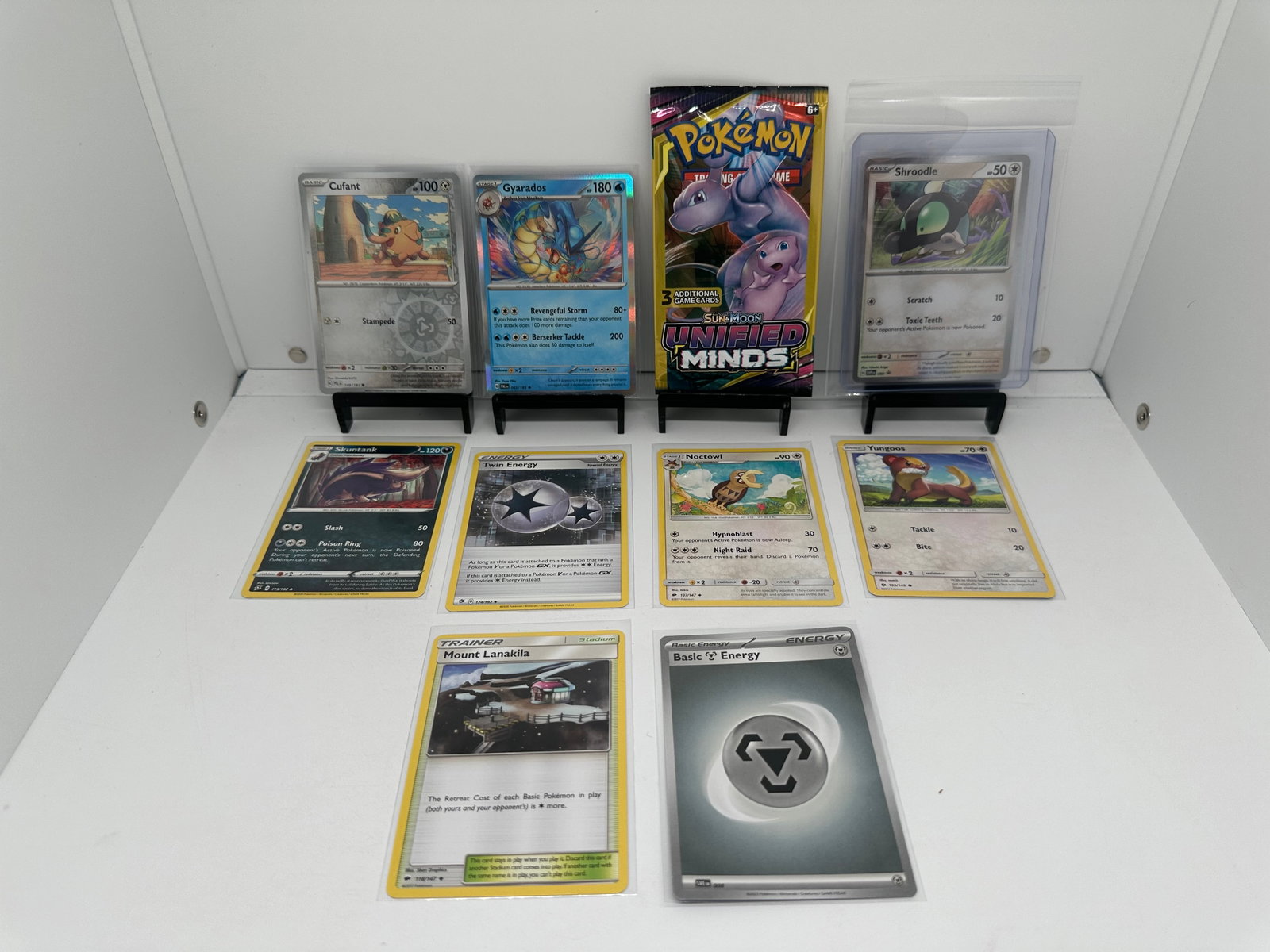 (10) TCG Pokemon Unified Minds pack, Gyarados Holo, Black Star Promo: * (9) TCG Pokemon cards from various sets and years. Add to your playing decks or complete your master sets. * Unified Minds pack sealed * Gyrados Holo * Shroodle Holo black star promo * Cufant Revers