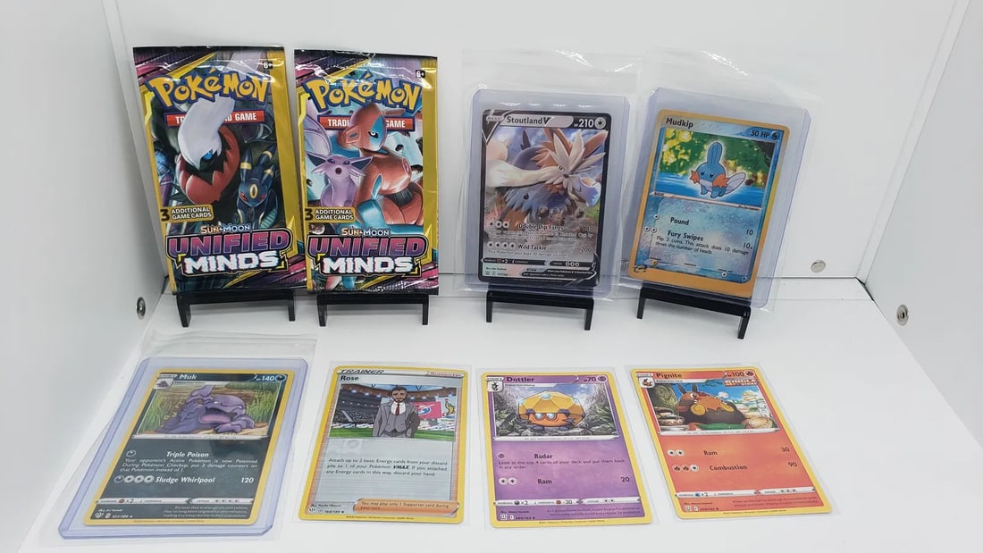 (8) TCG Pokemon Unified Minds packs, V, E-Reader: * 6 various pokemon cards from various sets and years * Add to your playing decks or complete your master sets. * Two Unified Minds packs * Stoutland V * Mudkip Reverse Holo Ruby and Sapphire * Rose R