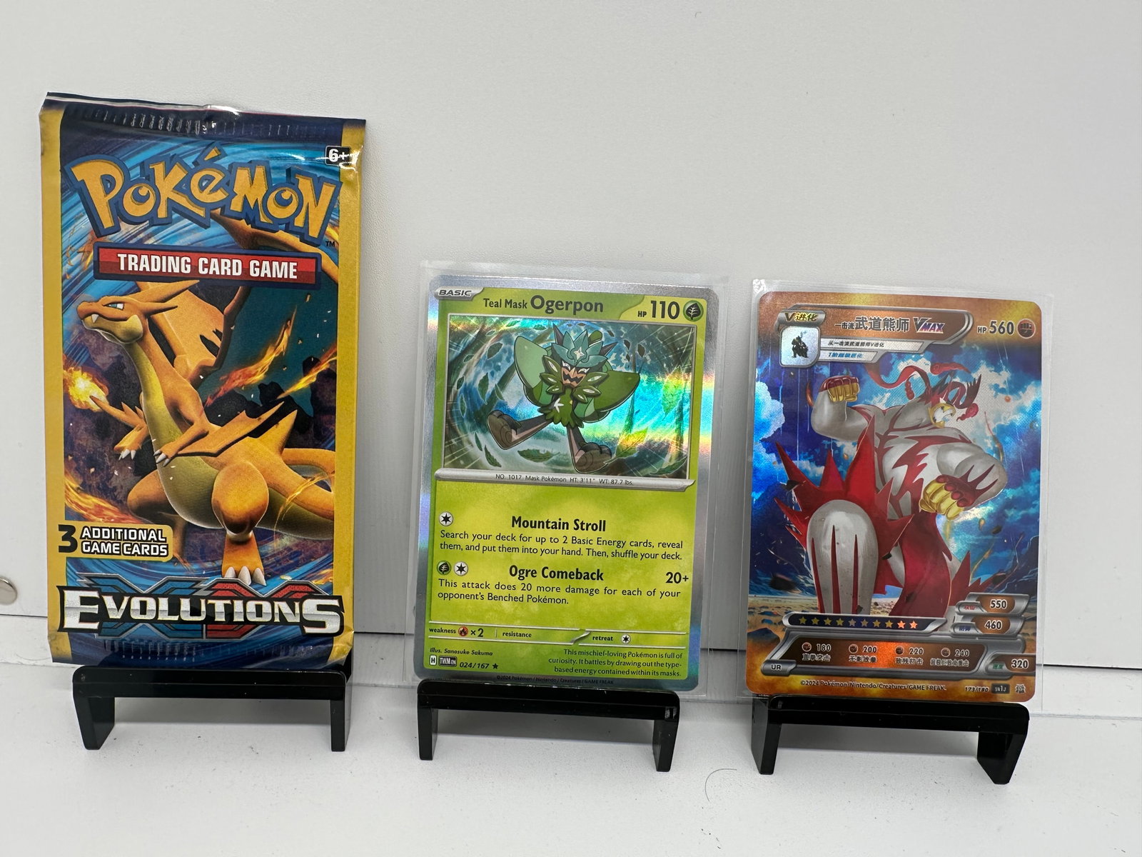 XY Evolutions pack, Ogerpon, Urshifu Vmax foil: * (2) TCG Pokemon cards from various sets and years. Add to your playing decks or complete your master sets. * XY Evolutions pack sealed Charizard art list * Ogerpon Holo * Urshifu Vmax foil