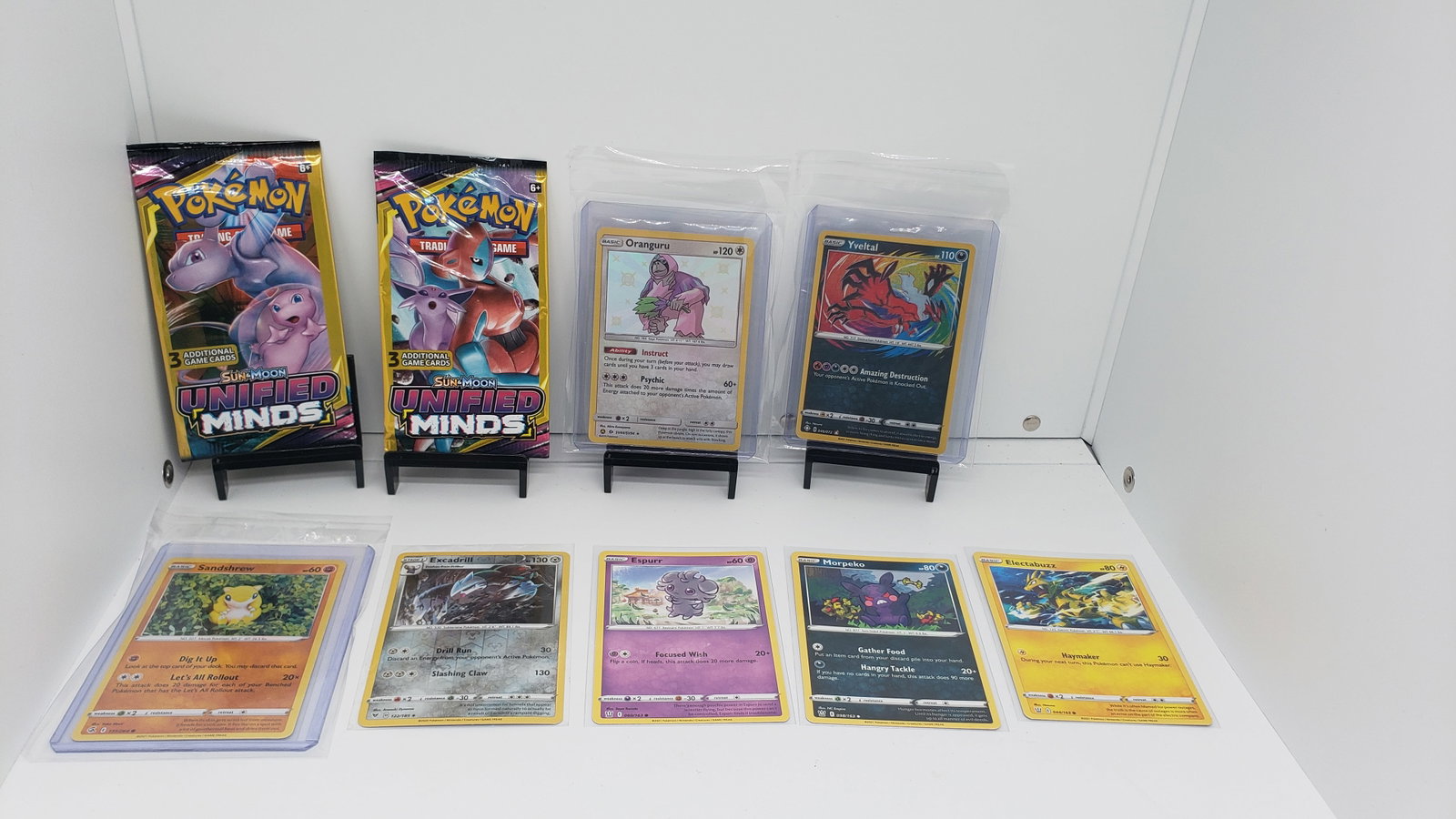 (9) TCG Pokemon Unified Minds packs, Baby Shine, Amazing Rare: * 8 various pokemon cards from various sets and years * Add to your playing decks or complete your master sets. * Two Unified Minds packs * Oranguru baby shine * Yveltal Amazing Rare.