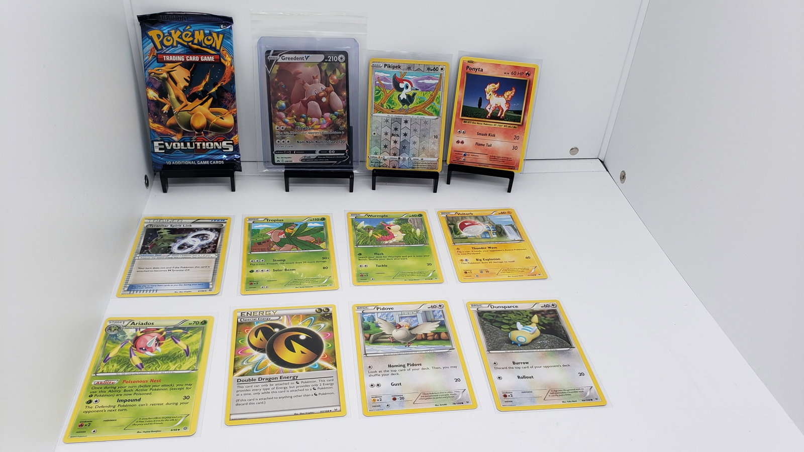 (12) TCG Pokemon XY Evolutions, V, Evolutions: 11 various pokemon cards from various sets and years. Add to your playing decks or complete your master sets. * XY Evolutions pack sealed * Greedent V * Pikipek Reverse Holo * Ponyta Evolutions * Tyra