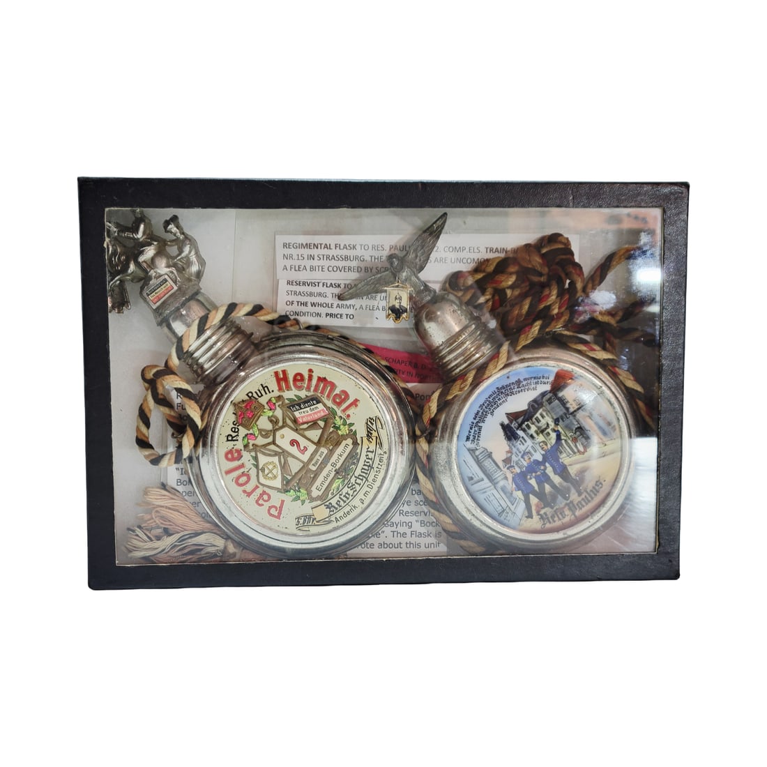 Military Canteens, German Regimental Flasks, Pair of Regimental Flasks: 2 Porcelain and metal hand enameled flaks, 2.Comp.El5.Train Batt. No.15 Strafsburg 1907-1909 owner Reservist Paulas, uncommon, 5. Battr. 2.Comp. Emden-Borkum 1911-1913 owner Reservist Schaper