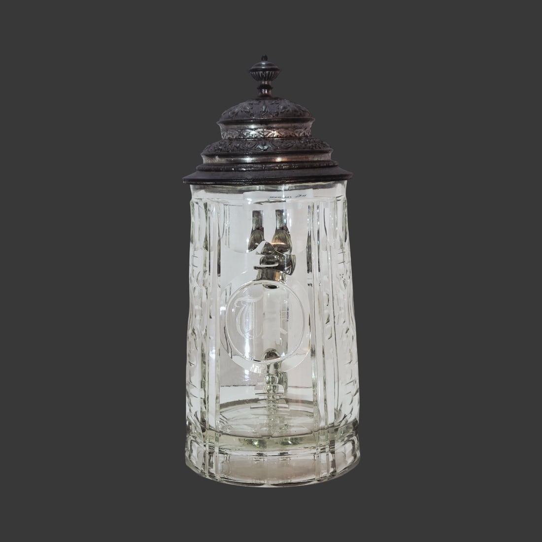 Glass Stein, Bohemian Beer Stein, Initial Stein: 1/2 Liter blown colorless glass, inset cut flared rim with 4 vertical rib cuts with numerous circular and partial oval cuts bordering the center circle cut with engraved initials T.P., has a recessed 