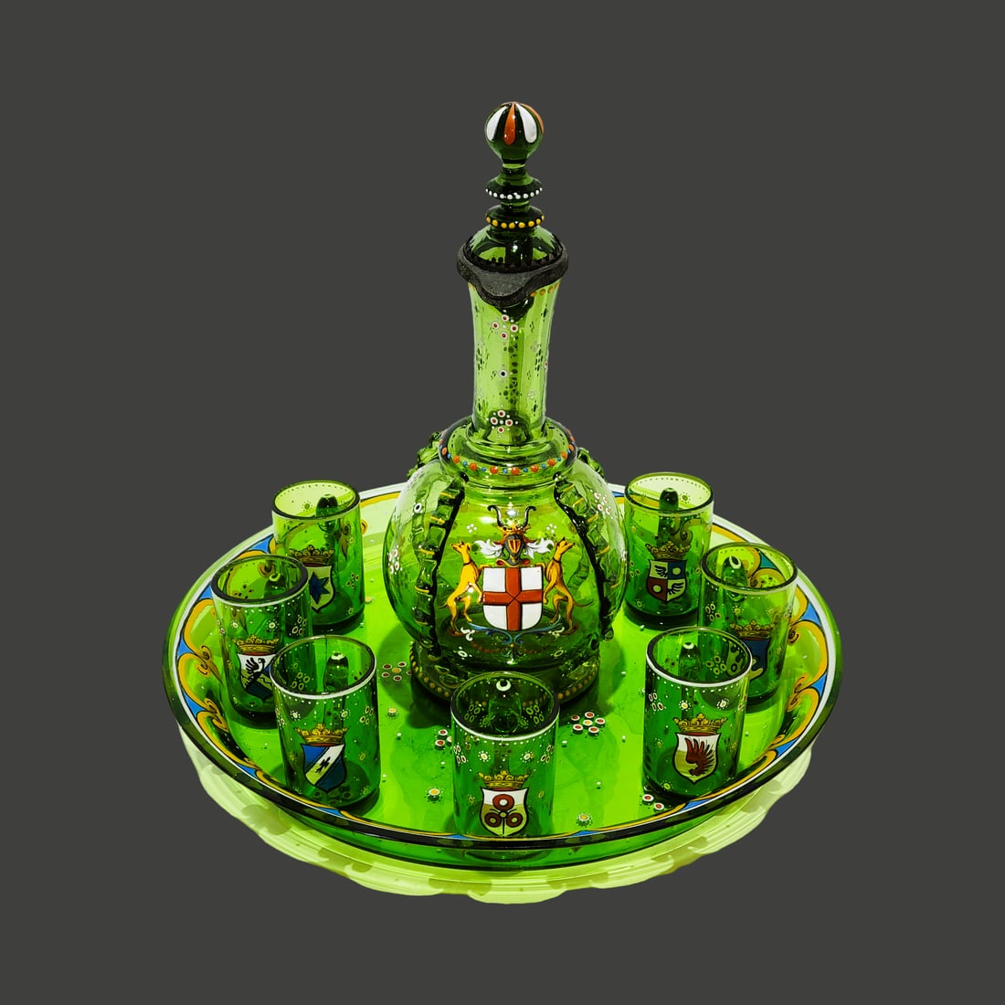Fritz Heckert Liqour Set, German Decanter Set, Armorial Liquor Set: Blown green glass with bubbles, hand enameled with a fleur-de-lies border and other florals. Decanter is 8 1/2" Tall by 3 1/2" Wide bulbous blown green glass with applied foot with polished pontil, ha