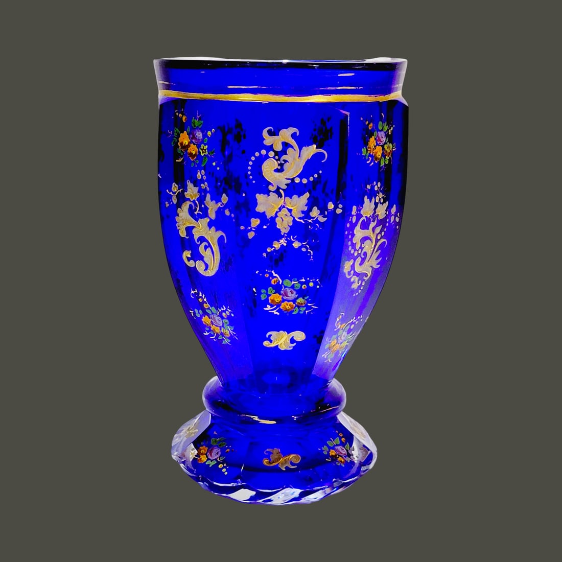 Glass Beaker, Bohemian Glass Beaker, Cobalt Cased Beaker: 5 1/8" Tall by 2 7/8" Wide blown cased cobalt with clear colorless glass overlay, hand enameled with florals over 8 cut facets, beautiful flared base under a rounded rib with facets and spiral cuts fo