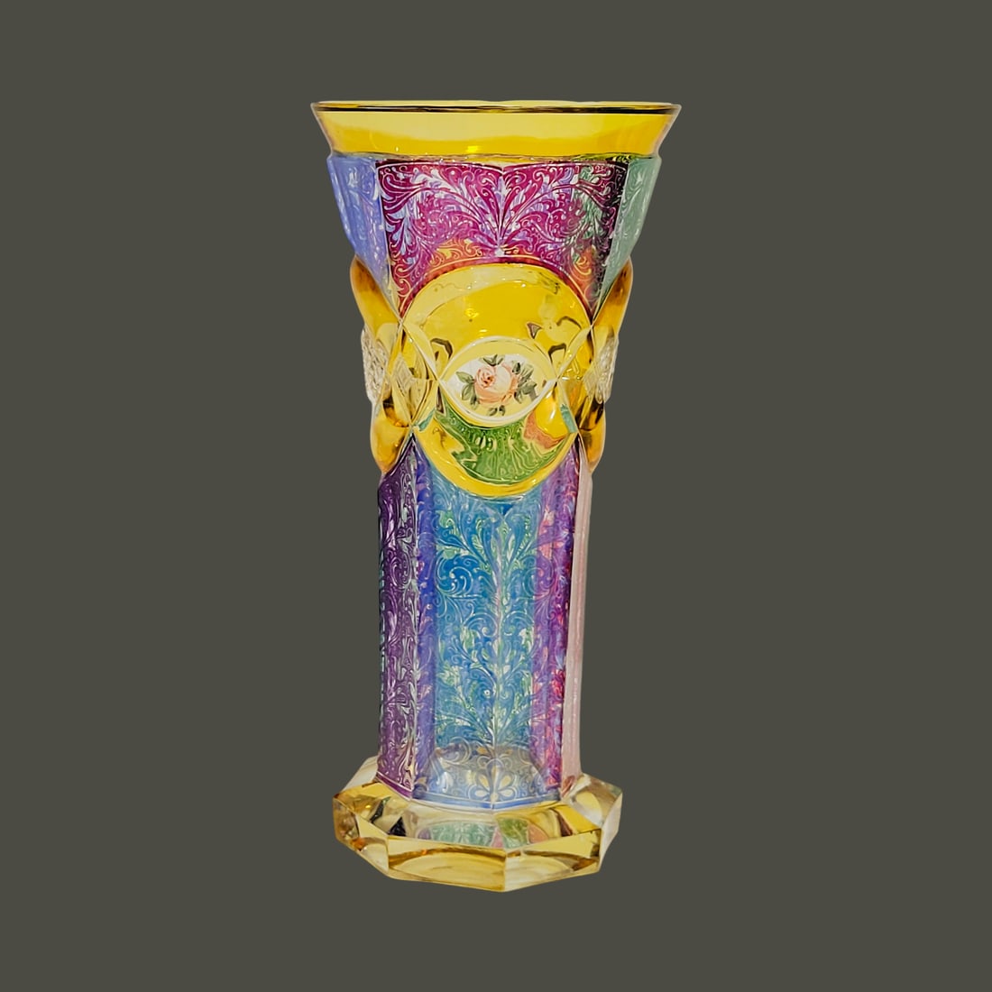 Frederich Egermann Vase, Bohemian Vase, Flared Engraved Vase: 7 5/8" Tall by 3 5/8" Wide blown colorless glass, it is stained with amber, blue, purple, green, and violet colors in an alternating fashion, flared at the polished amber stained rim the body is cut w