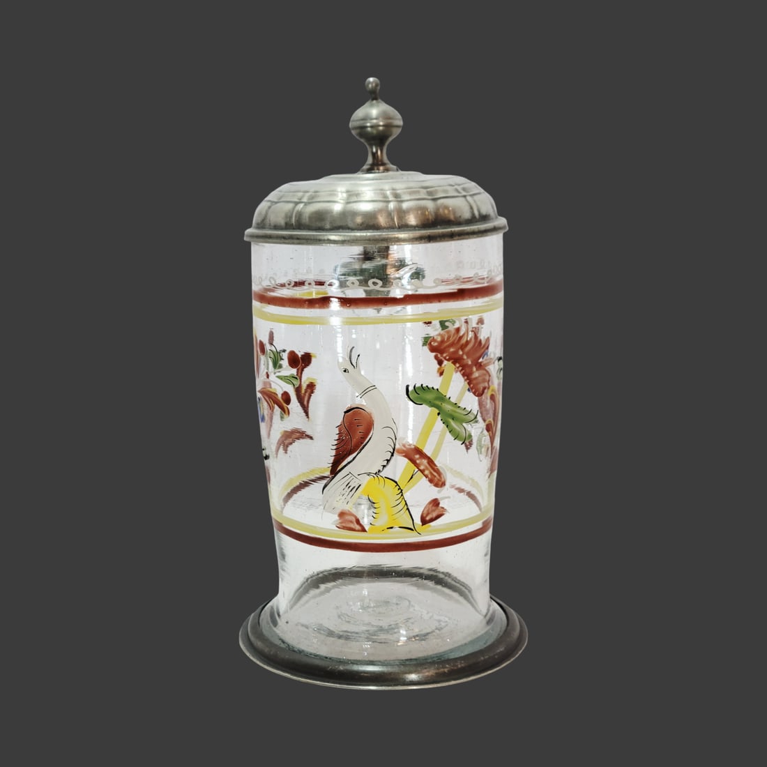 Biedermeier Conical Stein, Bohemian Beer Stein, Bird with Florals: 0.75 Liter blown colorless glass with bubbles and impurities, hand enameled horizontal top border consisting of white scalloping and red and yellow lines, hand enameled bird with flowers a top a horiz