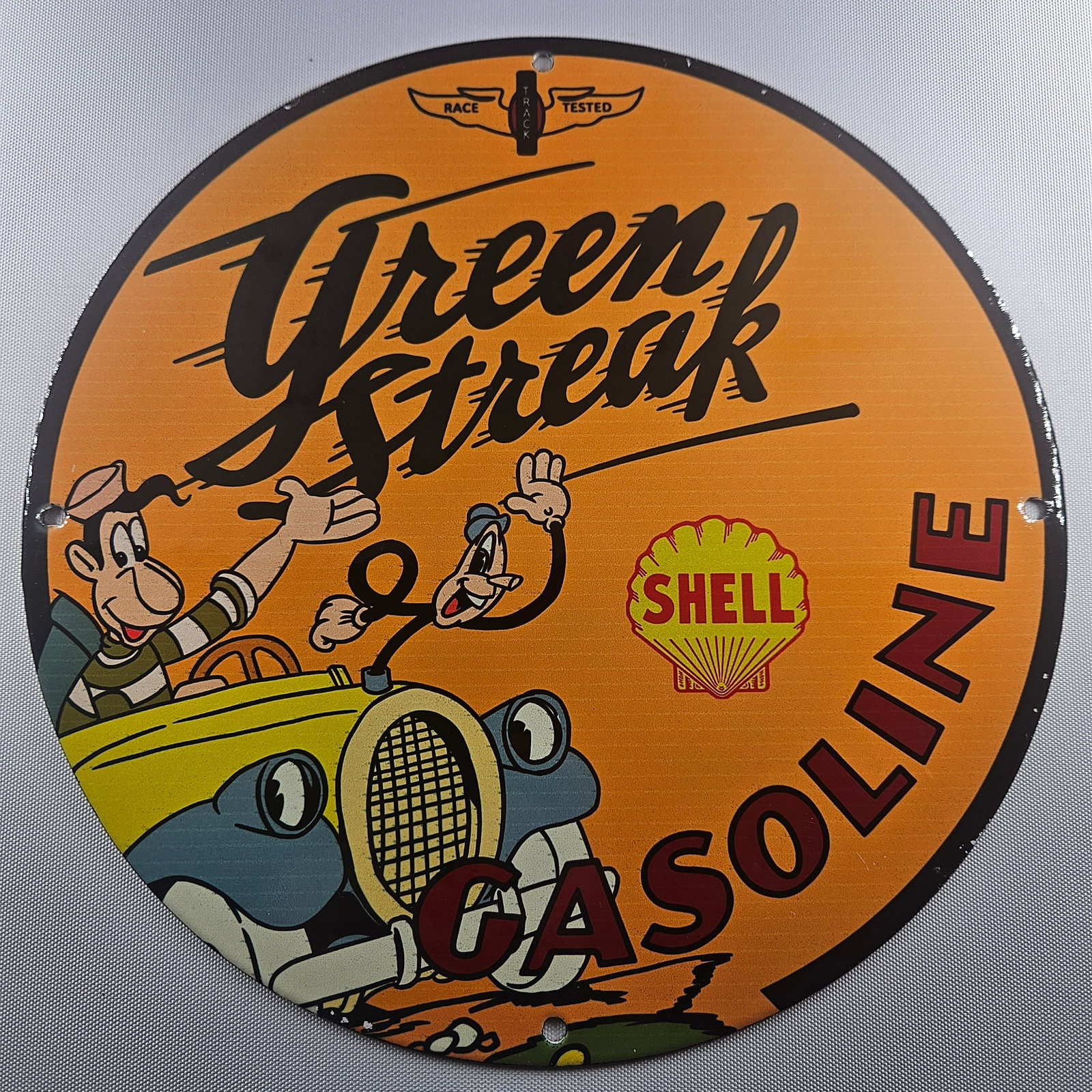 Shell Green Streak Gasoline 12-inch Porcelain Sign: The Shell Green Streak Gasoline 12-inch Porcelain Sign is a captivating piece of advertisement history, showcasing the classic Green Streak design synonymous with Shell's rich heritage in the fuel ind