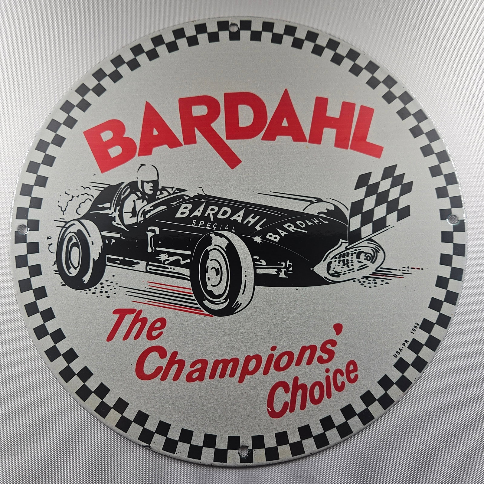 Bardahl Special Motor Oil 12-inch Porcelain Sign: The Bardahl Special Motor Oil 12-inch Porcelain Sign is a captivating piece of advertisement history, showcasing the distinctive Bardahl logo. Measuring 12 inches in diameter, this sign represents the