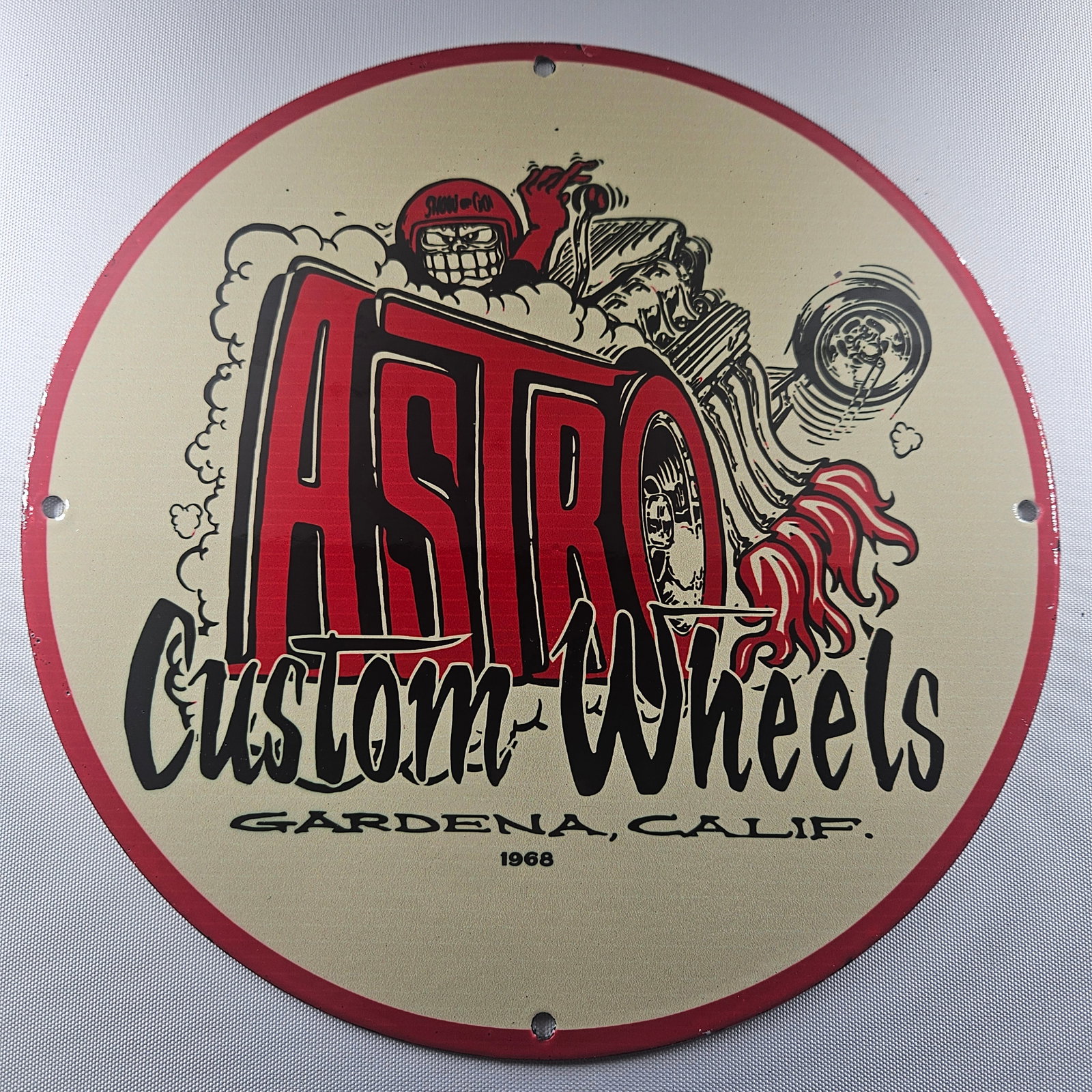 1968 Astro Custom Wheels 12-inch Porcelain Sign: The 1968 Astro Custom Wheels 12-inch Porcelain Sign is a captivating piece of advertisement history, showcasing the distinctive Astro Custom Wheels logo from the iconic year of 1968. Measuring 12 inch