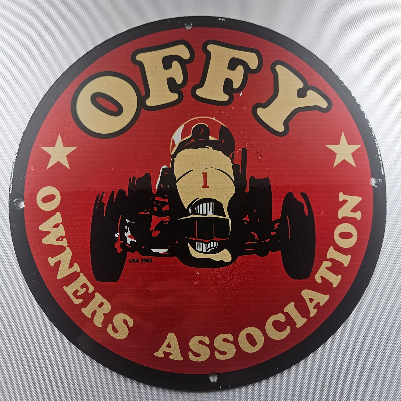1968 Offy Owners Association 12-inch Porcelain Sign: The 1968 Offy Owners Association 12-inch Porcelain Sign is a distinctive piece of advertisement history, featuring the emblematic logo of the Offy Owners Association from 1968. Measuring 12 inches in 