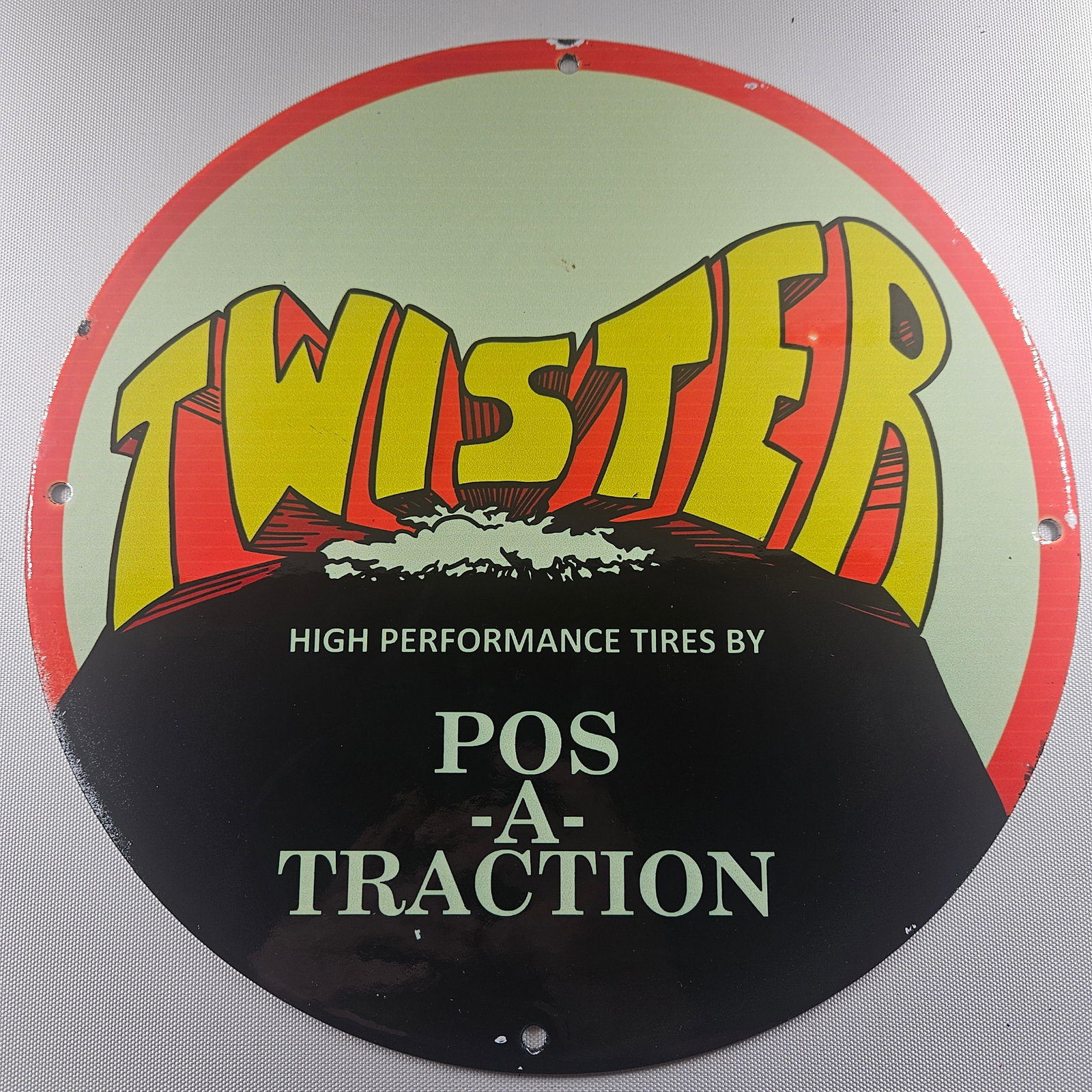 Twister High Performance Tires 12-inch Porcelain Sign: The Twister High Performance Tires 12-inch Porcelain Sign is a captivating piece of advertisement history, featuring the distinctive logo of the esteemed Twister High Performance Tires brand. Measurin