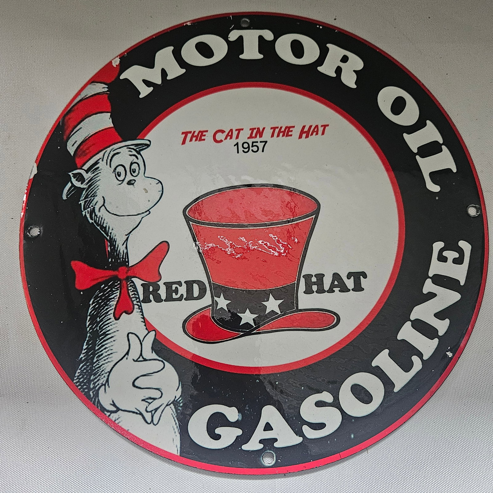 1957 'The Cat in the Hat' Motor Oil and Gasoline Porcelain Sign - Whimsical Automotive Elegance: Turn the page back to 1957 with this delightful porcelain sign featuring 'The Cat in the Hat,' a beloved character that has brought joy to generations of readers. This sign blends the magic of storyte