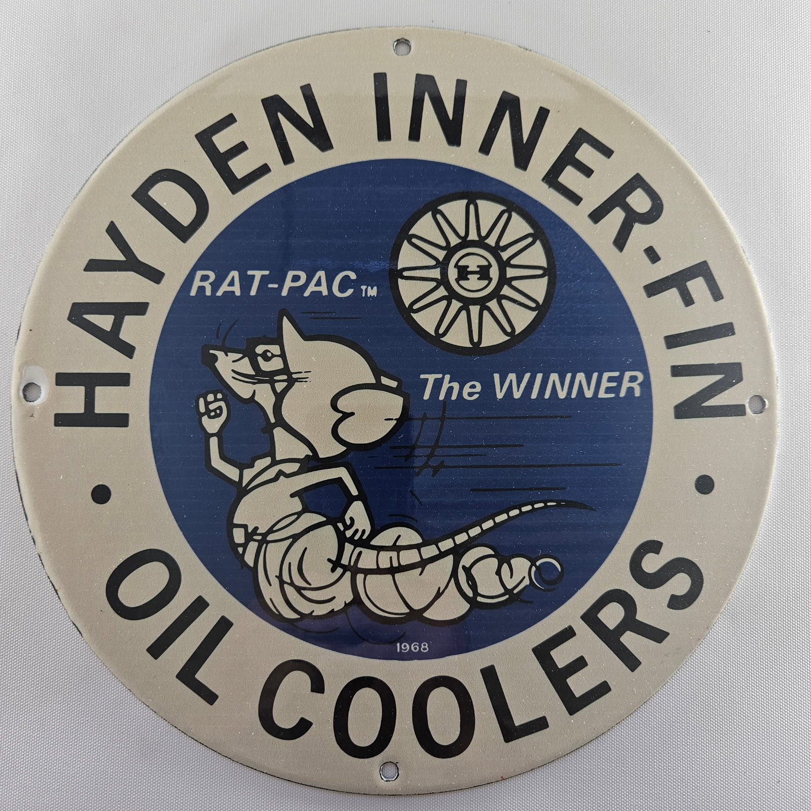 1968 HAYDEN INNER-FIN OIL COOLERS GAS OIL GARAGE MAN CAVE PORCELAIN SIGN: Immerse yourself in the nostalgia of automotive history with this Hayden Inner-Fin Oil Coolers memorabilia. Measuring approx. 12 inches, this piece showcases a classic advertisement from 1968, capturi