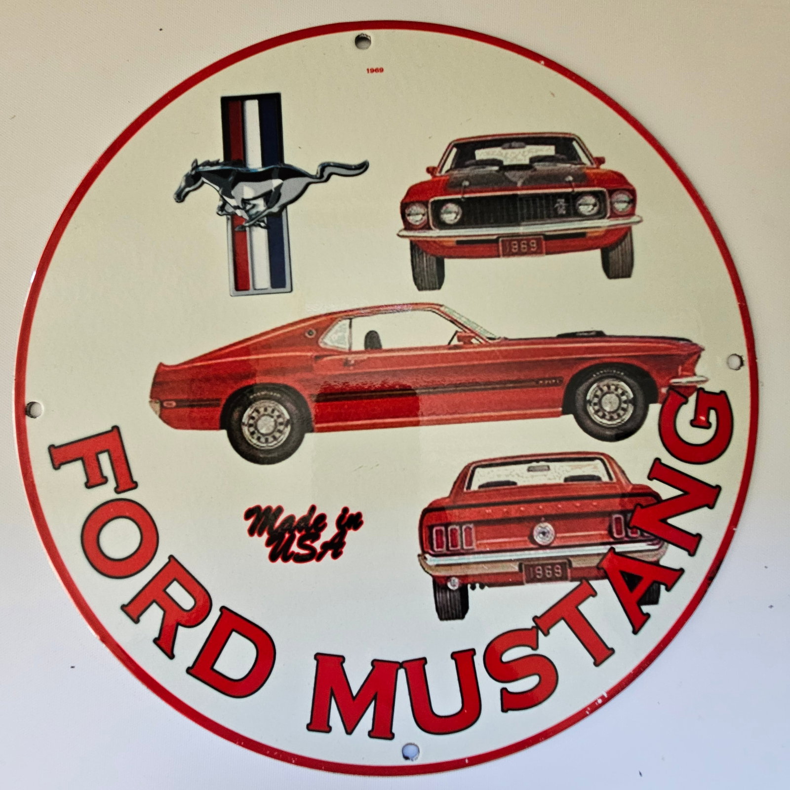 1969 FORD MUSTANG GAS OIL GARAGE MAN CAVE PORCELAIN SIGN: The 1969 Ford Mustang sign, measuring approximately 12 inches in diameter, is a captivating piece of advertisement history, embodying the spirit of American automotive excellence. Its sleek design and