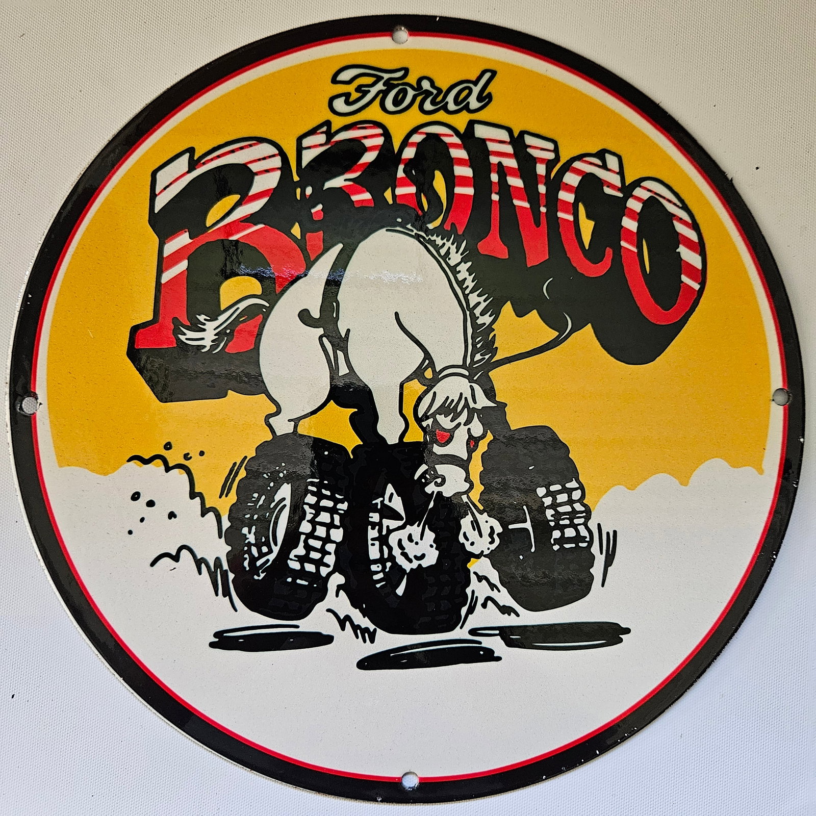 FORD BRONCO GAS OIL GARAGE MAN CAVE PORCELAIN SIGN: Introducing the iconic FORD BRONCO sign, a timeless piece of advertising history measuring approximately 12 inches in diameter. This sign embodies the rugged spirit and adventurous appeal of the class