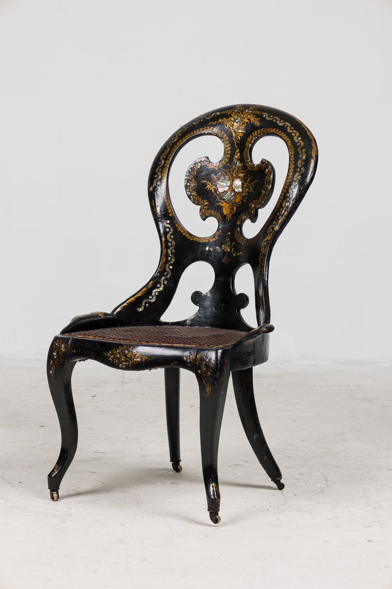 English Victorian Pearl Inlaid Japanned Side Chair: 19th c. England, black lacqured papier mache side chair with mother-of-pearl floral inlay and cane seat, 19.5"l x 22"d x 25"h