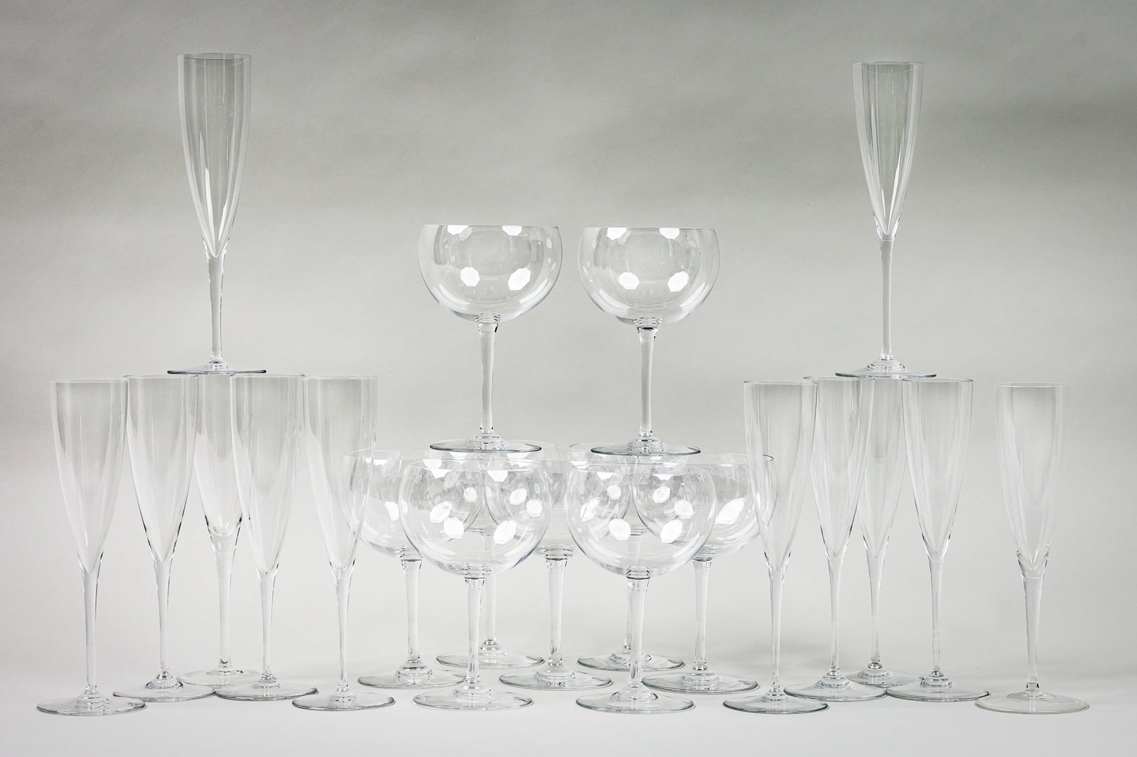 Baccarat (12) Champagne Flute & (9) Wine Glasses: 21st c., France, elegant Dom Perignon pattern champagne flutes, 9.5"h x 3"w x 3", and Pavillon (Chambertin) pattern wine glasses, marked, 7"h x 3.5"w x 3.5"d Provenance: Property from an 875 Park Ave