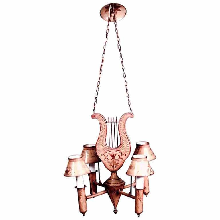 French Directoire Style Tole and Gilt Lyre Chandelier: French Directoire-Style (20th Century) mustard tole and gilt trimmed 4 arm chandelier with lyre top and shades.Dimensions: 20"w x 20"d x 20"h, 20"dia