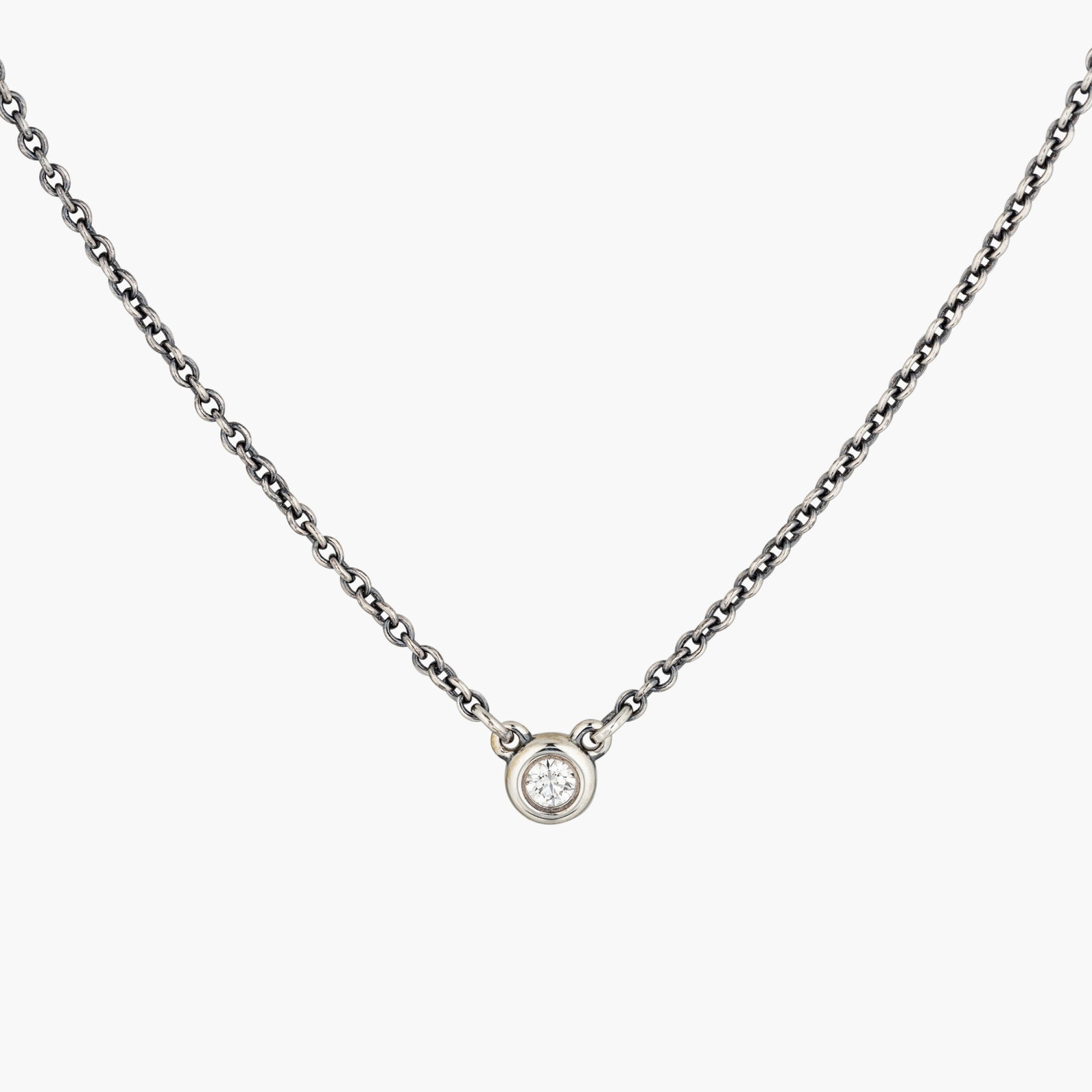 Single Diamond Pendant/Necklace By Elsa Paretti For Tiffany&Co.: Origin: Contemporary Metal: Silver Gemstones:Round brilliant cut diamond approx. 0.05 carats F-G/VS Measurements : 16 1/4 inches long Weight: 1.6 g Sign: Peretti; Tiffany&Co. Condition: In excelle