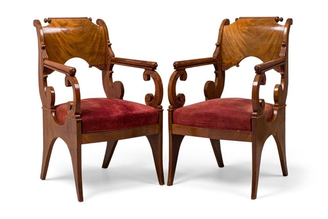 (2) Russian neoclassical mahogany scroll form armchairs: c. 19th/20th c. possibly, Russia, mahogany armchairs in elaborate scroll form with a curved upper backrest and arms, carved acanthus decoration with reeding and floral medallions, red suede upholstere